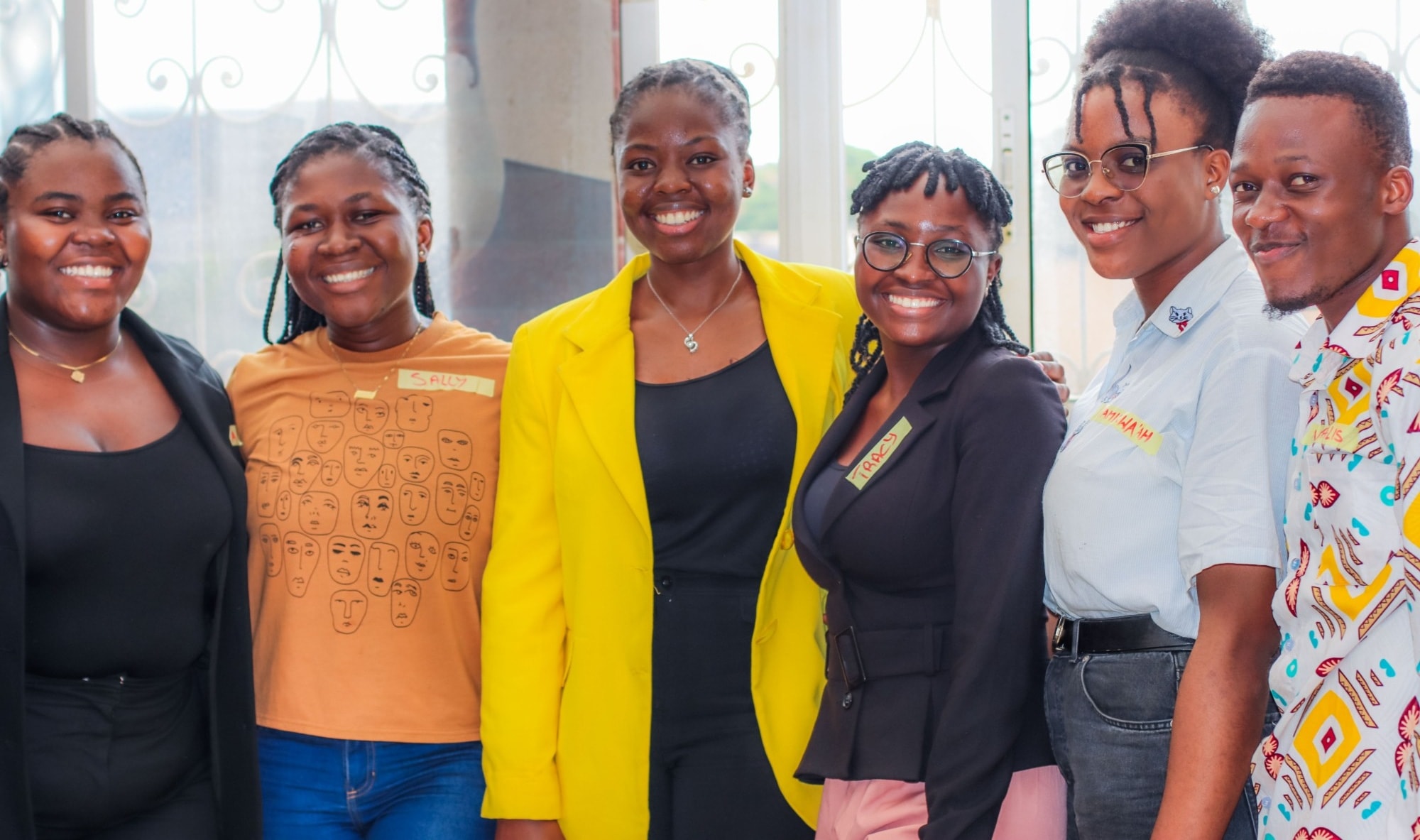 Six Goodwill Fellowship fellows standing shoulder to shoulder and smiling